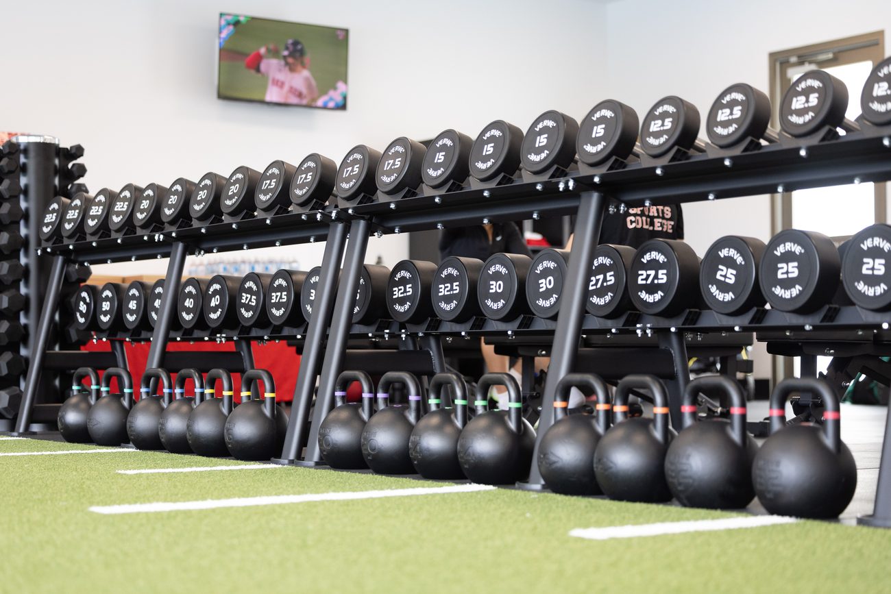 The VERVE dumbbell and competition kettlebell line along the turf track.